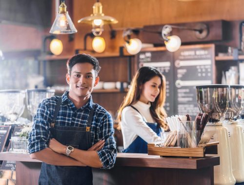 Portrait of Asian Young Small business owner with coffee shop in Portrait of Asian Young Small business owner with coffee shop in front of counter bar, entrepreneur and startup, preparing for service to customer in cafe store and restaurant,business partner concept